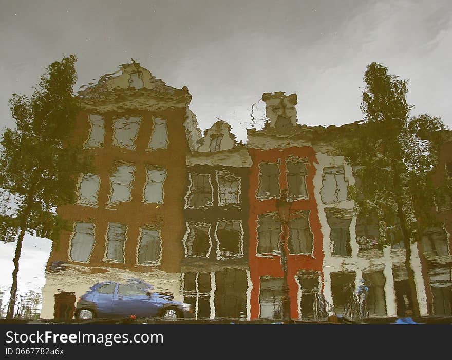 A typical Amsterdam series of building reflected on the calm water of a canal. Image is rotated by 180 degrees. A typical Amsterdam series of building reflected on the calm water of a canal. Image is rotated by 180 degrees.