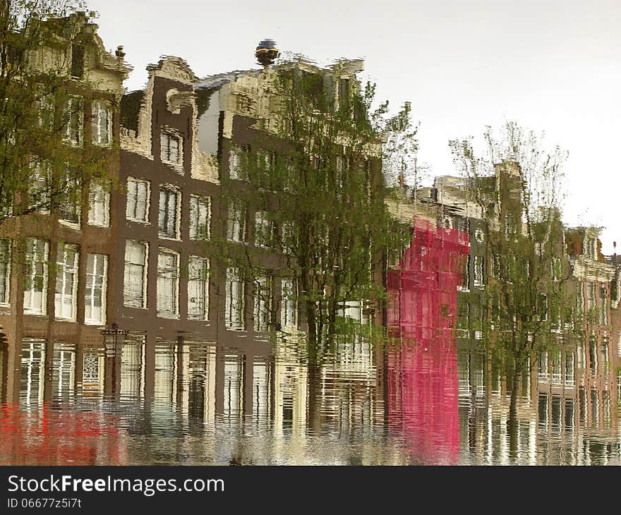 A typical Amsterdam series of building reflected on the calm water of a canal. Image is rotated by 180 degrees. A typical Amsterdam series of building reflected on the calm water of a canal. Image is rotated by 180 degrees.