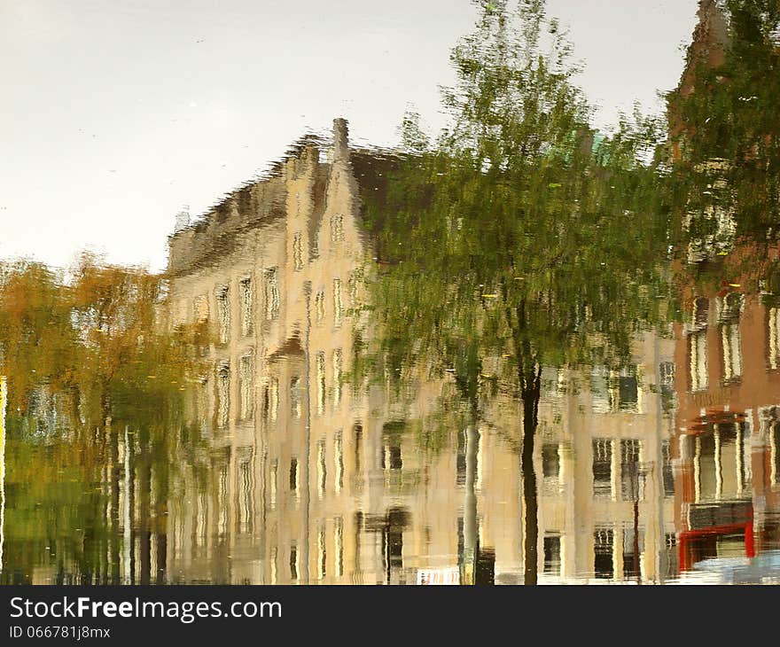 A typical Amsterdam series of building reflected on the calm water of a canal. Image is rotated by 180 degrees. A typical Amsterdam series of building reflected on the calm water of a canal. Image is rotated by 180 degrees.