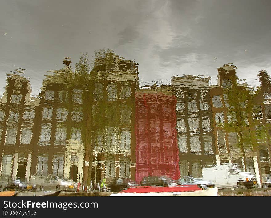 A typical Amsterdam series of building reflected on the calm water of a canal. Image is rotated by 180 degrees. A typical Amsterdam series of building reflected on the calm water of a canal. Image is rotated by 180 degrees.