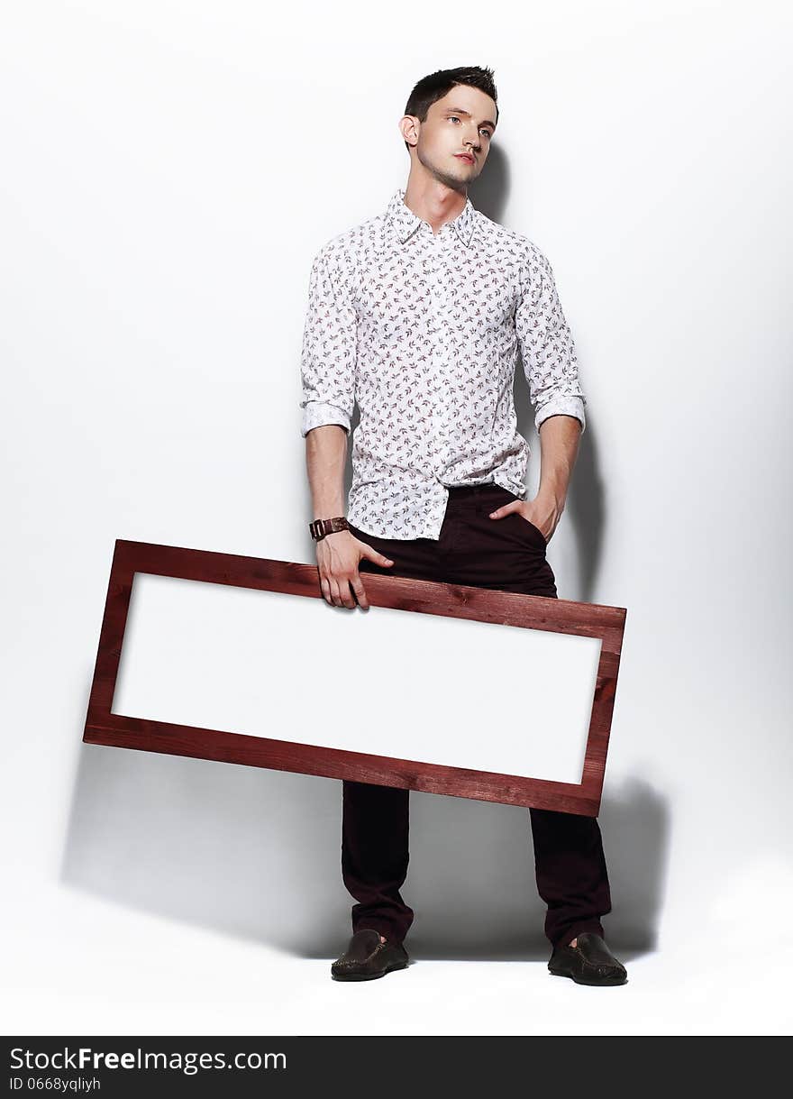 Fashion Man Holding Board With White Blank Space For Text