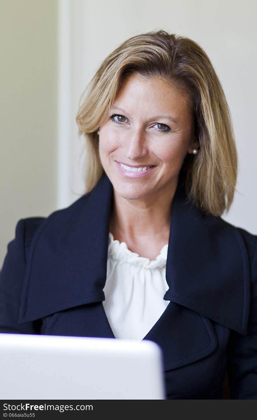 Proud Businesswoman Smiling At Home Office Using Laptop