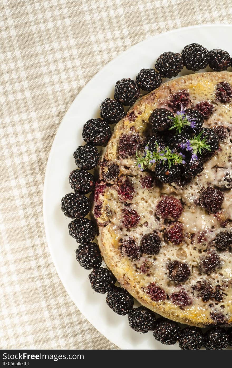 Blackberry Clafoutis on plate with fresh berries