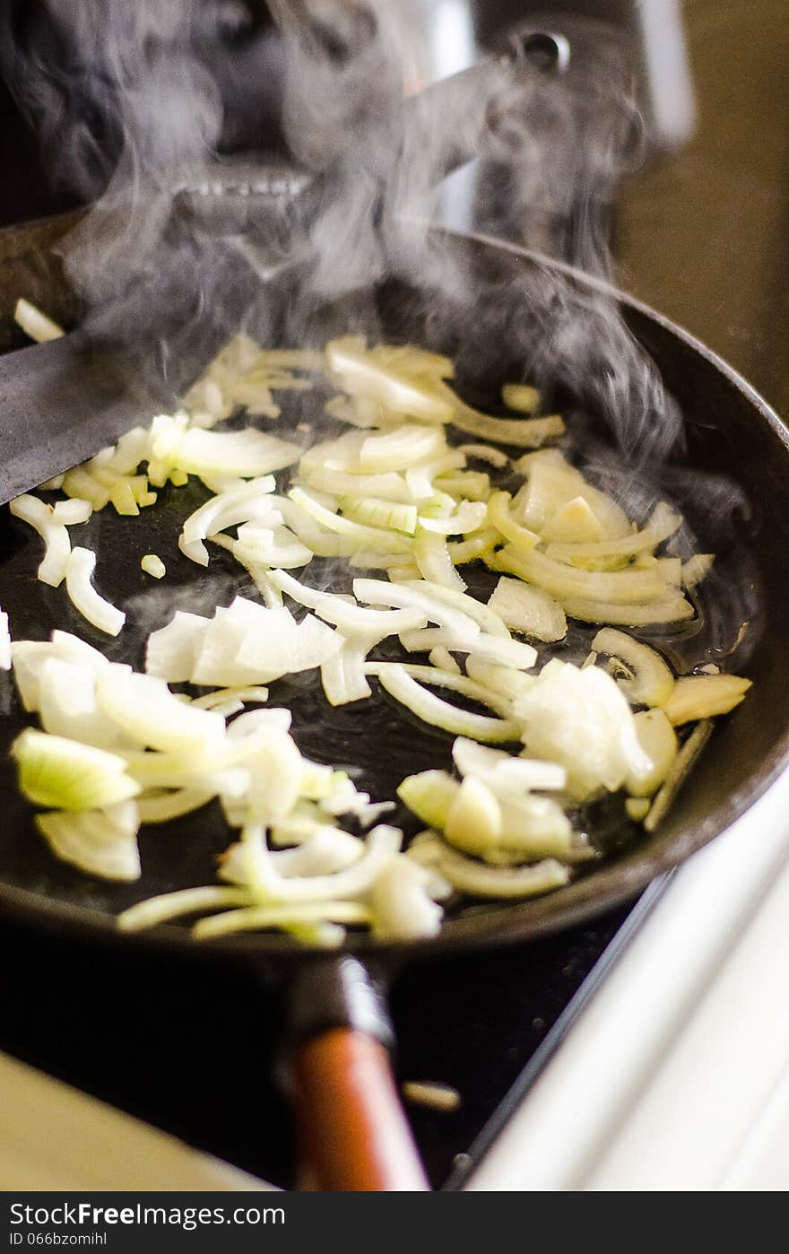 Frying onion in an iron-cast pan