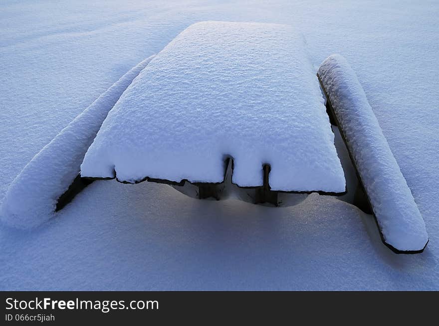 Snow-covered table and benches