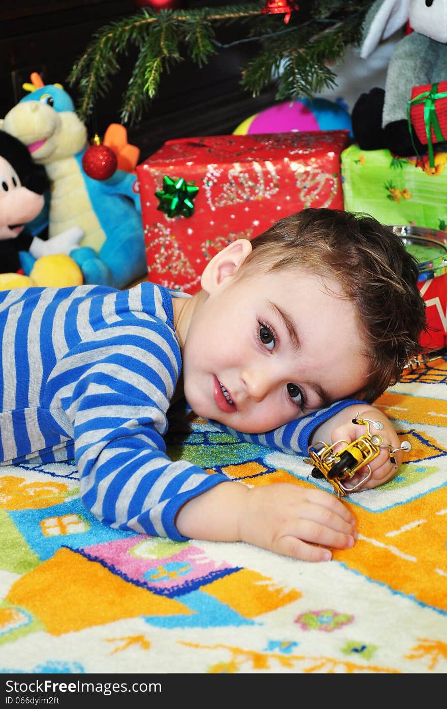 A portrait of. a happy baby boy sitting on the floor playing with toys. A portrait of. a happy baby boy sitting on the floor playing with toys