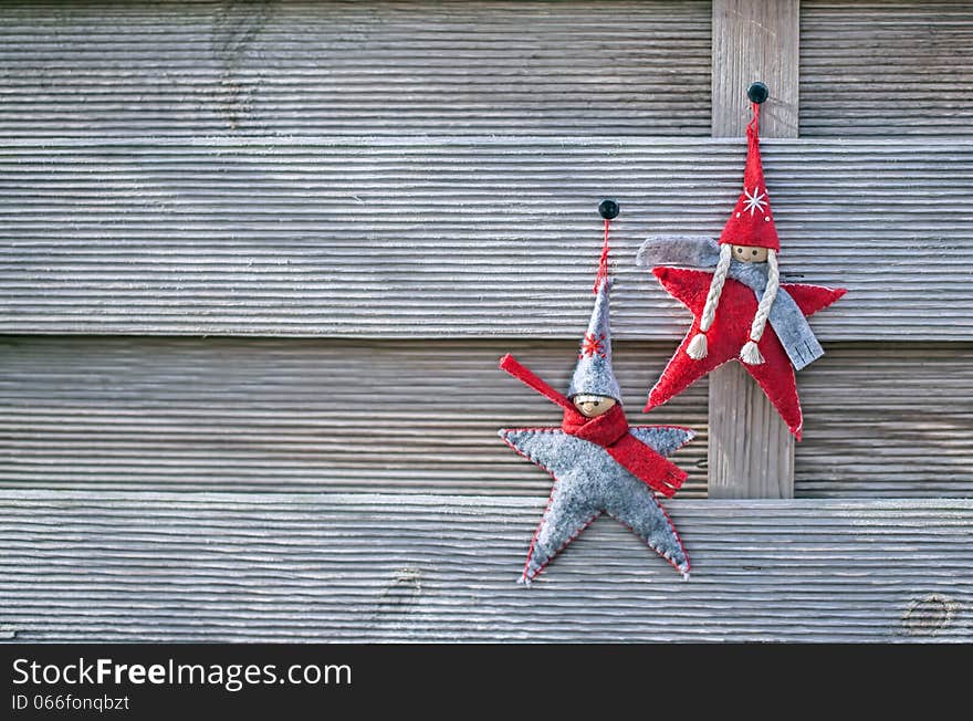 Two gnome hanging on grey wooden background. Two gnome hanging on grey wooden background