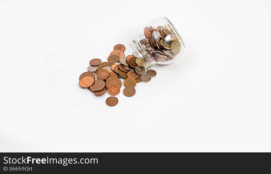 Coins  spilt from jar