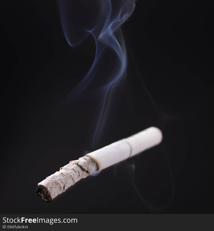 Cigarette as a symbol of human dependence on addictions. Cigarette as a symbol of human dependence on addictions