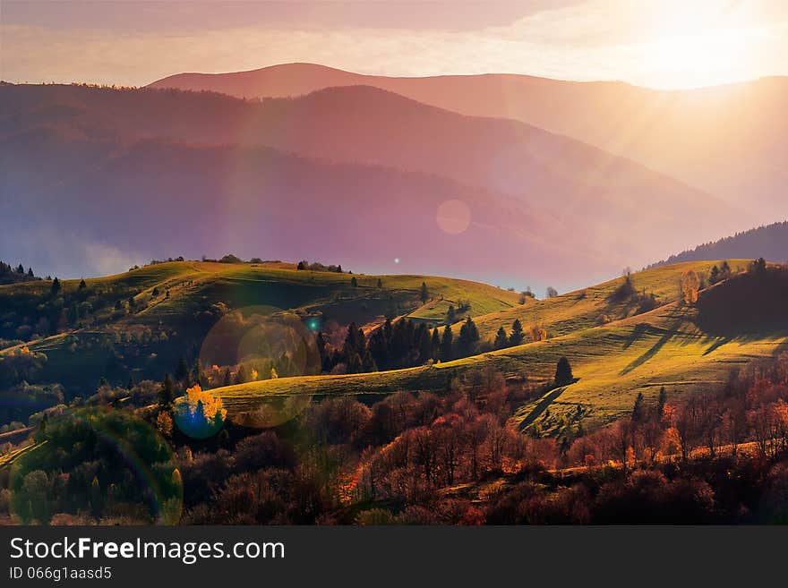 Autumn landscape. forest on a hillside covered with red and yellow leaves. over the mountains. Autumn landscape. forest on a hillside covered with red and yellow leaves. over the mountains