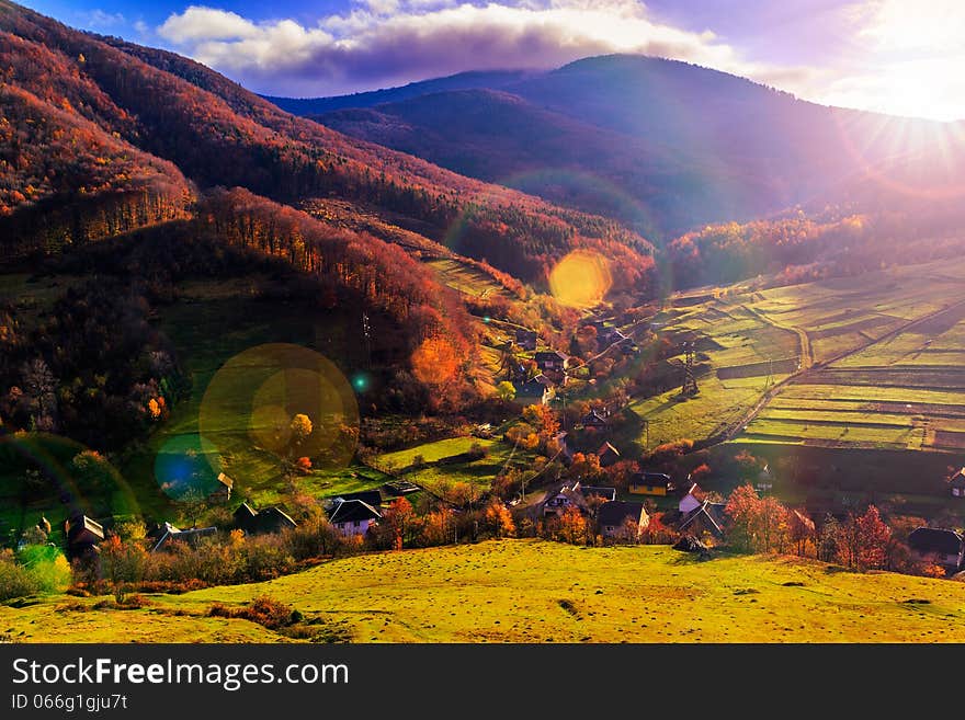 Light  beam falls on hillside with autumn forest in mountain