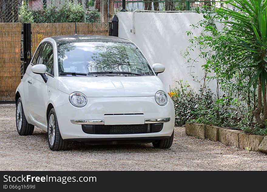 Small car outdoors. In private place.