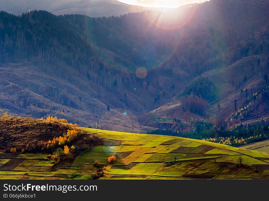 Autumn landscape. forest on a hillside covered with red and yellow leaves. over the mountains. Autumn landscape. forest on a hillside covered with red and yellow leaves. over the mountains