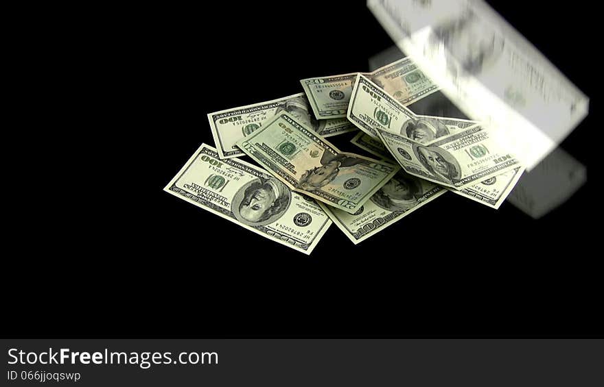 The dollars on a black background fall and the heap is going. The dollars on a black background fall and the heap is going