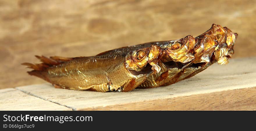 Smoked fish on brown background