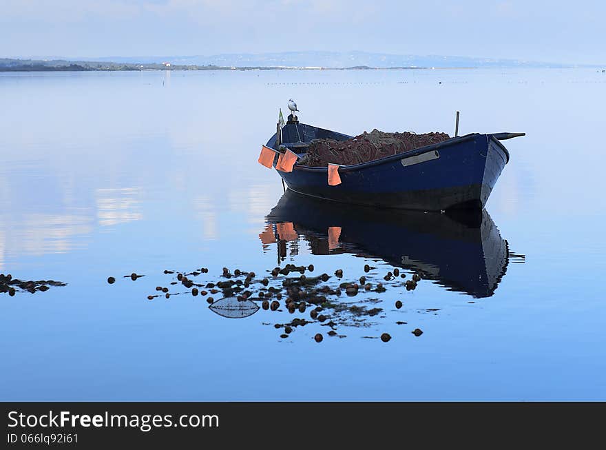 Fishing boat in calm lagoon and the blue bay. Fishing boat in calm lagoon and the blue bay.