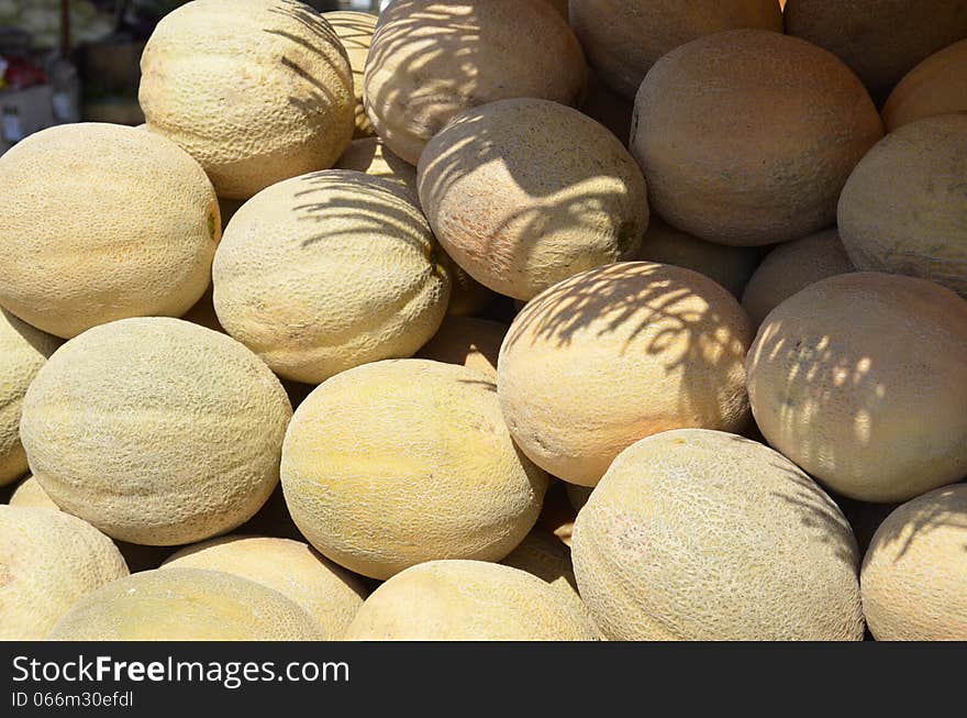 Fresh ripe cantaloupe for sale at an outdoor market