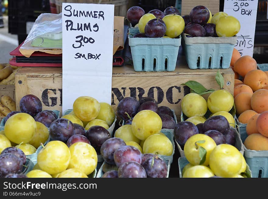 Fresh plums and a variety of produce for sale. Fresh plums and a variety of produce for sale