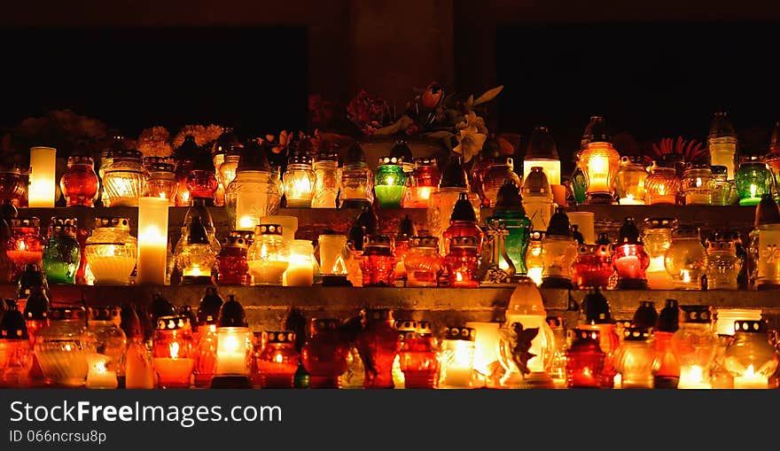 Burning candles at night in the cemetery.