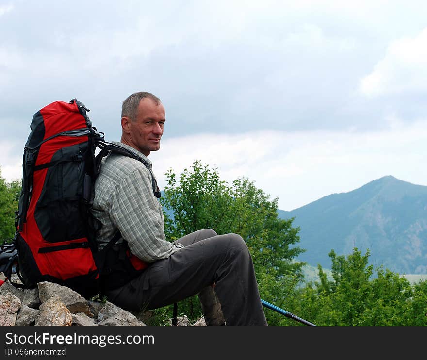 Spring in the Crimea. Family hiking. Hiker sat down to rest