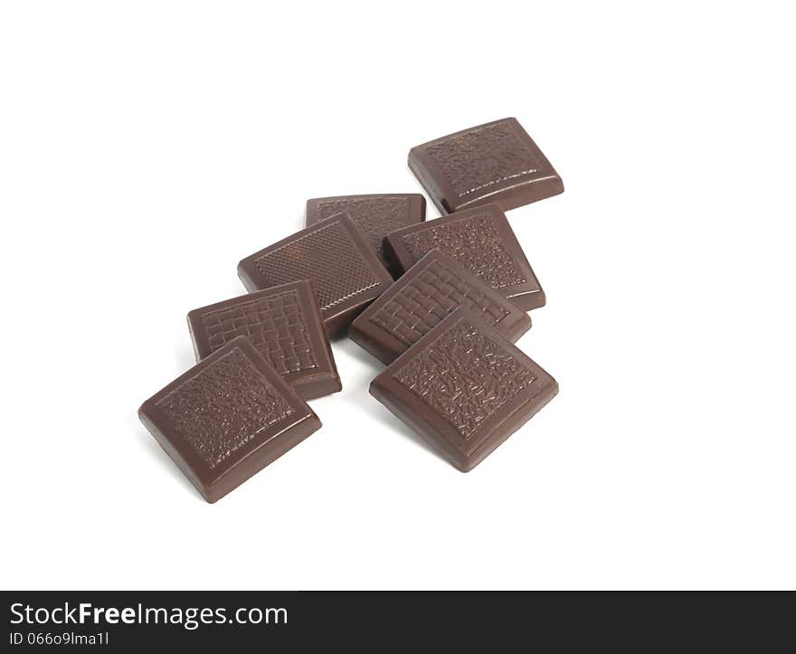 Close-up of chocolate pieces on a white background