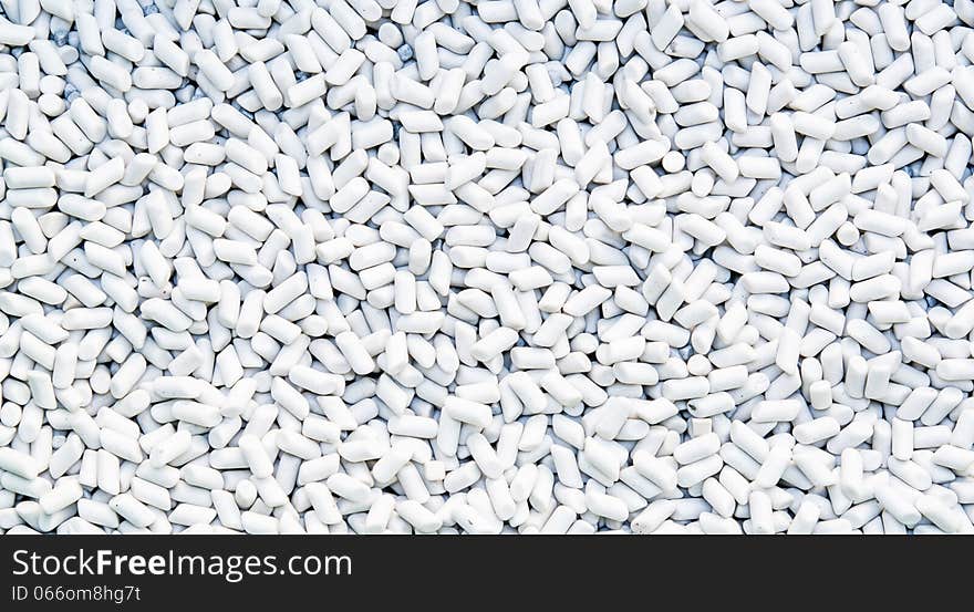 White cylinder stones on background