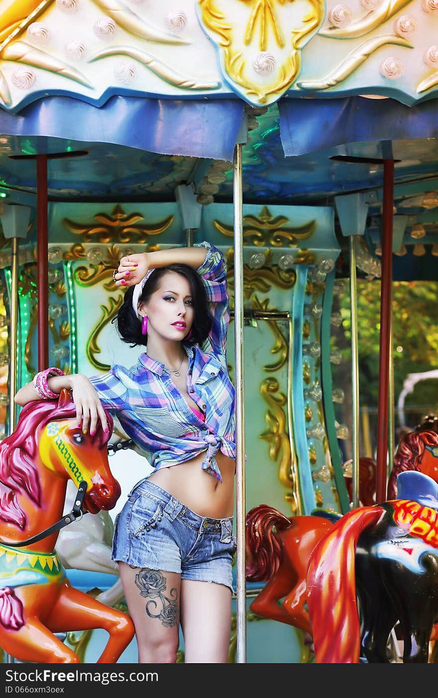 Merry-go-round. Playful Stylish Showy Woman in Roundabout. Funfair