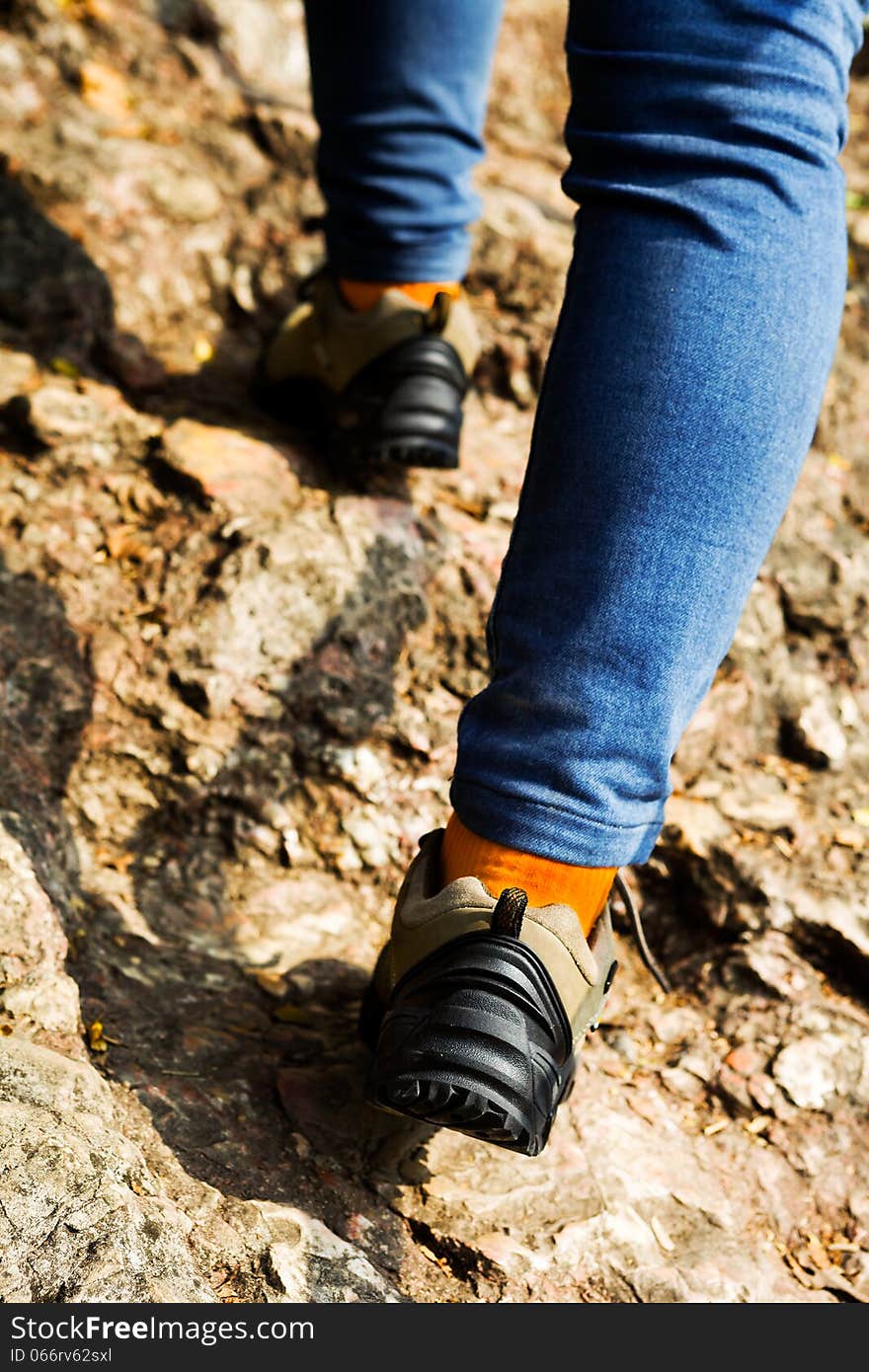 Woman hiking on a path in the mountain. Woman hiking on a path in the mountain