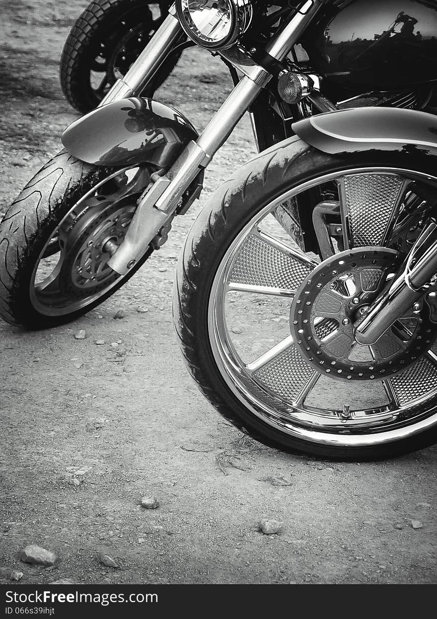 Wheels of the motorcycles. Motorbikes on the country road in retro style. Wheels of the motorcycles. Motorbikes on the country road in retro style.