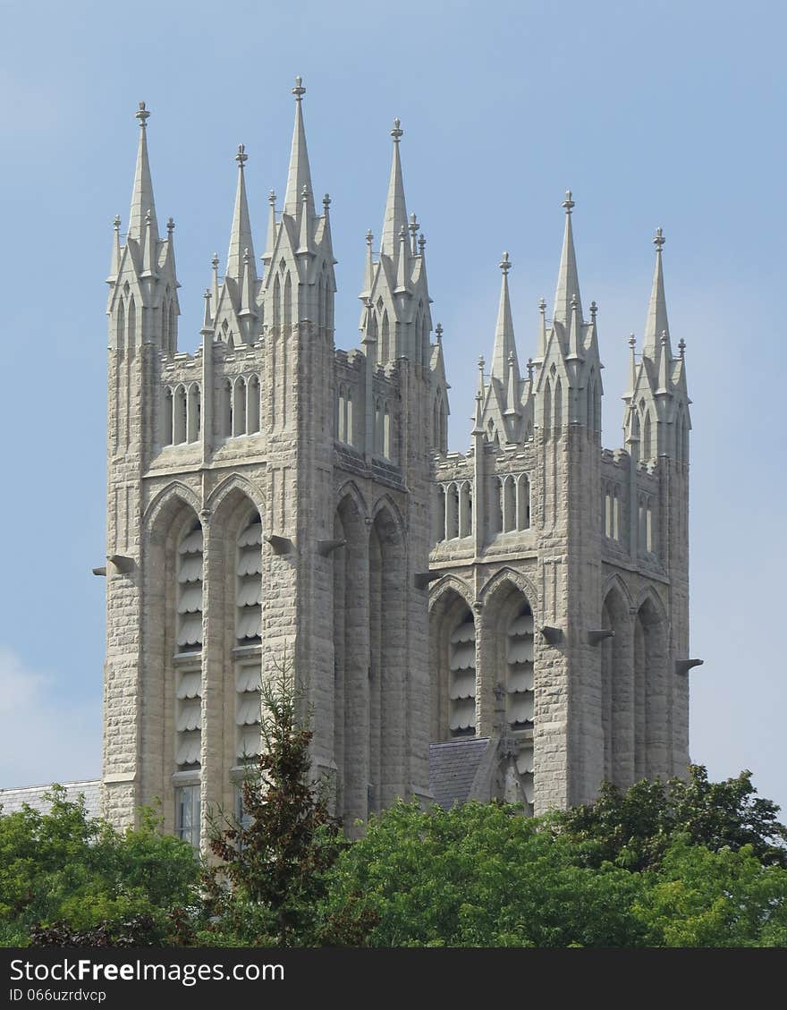 Spires and towers of an old Christian cathedral, with trees at the bottom. Against a blue sky. Spires and towers of an old Christian cathedral, with trees at the bottom. Against a blue sky.