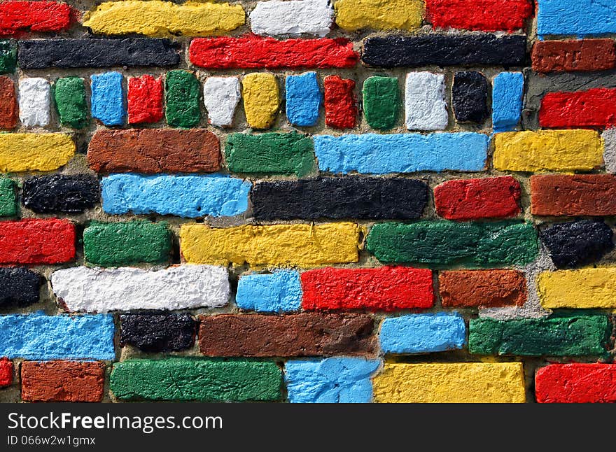 Wall of red, yellow, white, black, green and blue bricks. Wall of red, yellow, white, black, green and blue bricks