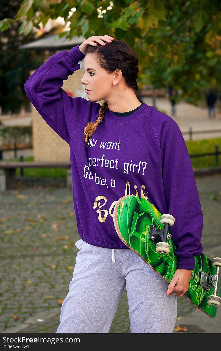 Beautiful young woman on the city with skateboard. Beautiful young woman on the city with skateboard