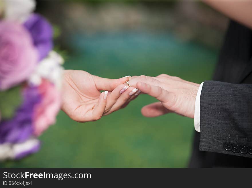 Groom and bride hands on wedding ceremony outdoor