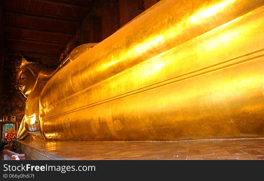 Reclining Buddha gold statue face. Wat Pho, Bangkok, Thailand