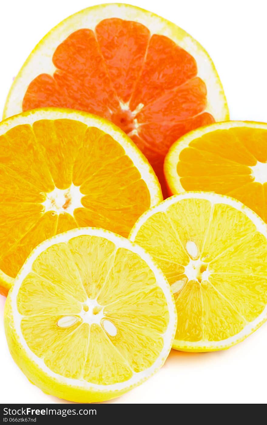 Halves of Fresh Ripe Grapefruit, Oranges and Lemons closeup on white background. Halves of Fresh Ripe Grapefruit, Oranges and Lemons closeup on white background