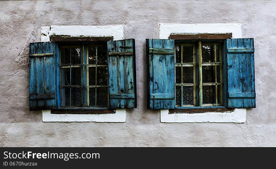 Two old windows with blue shutters. Two old windows with blue shutters.