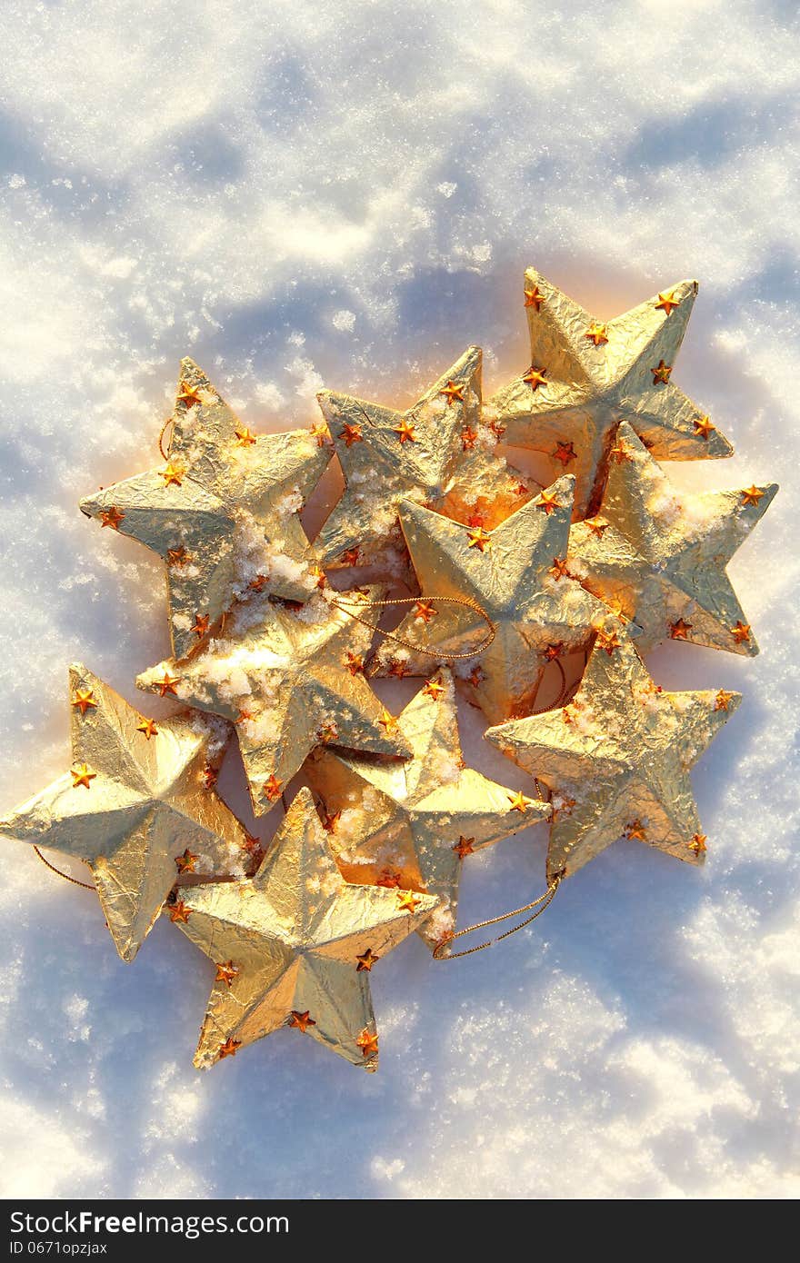 Golden christmas stars in the snow in sunny winter day. Golden christmas stars in the snow in sunny winter day