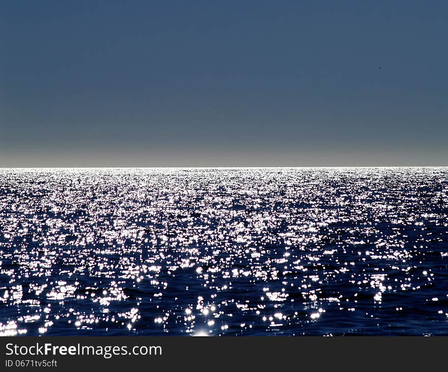 Patches of reflected sunlight on the sea. Patches of reflected sunlight on the sea.