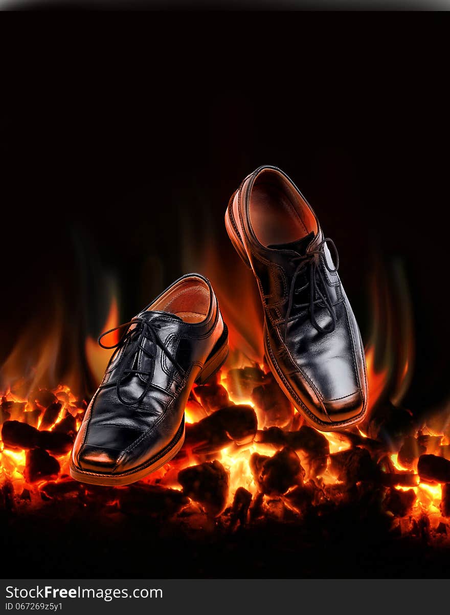 Business shoes dancing over fire