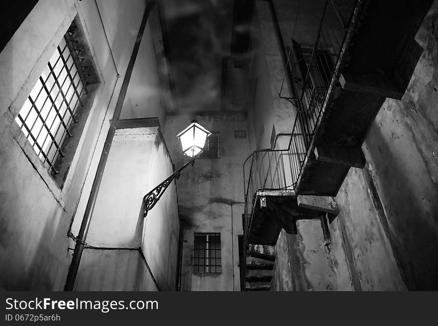 Spooky night scene with street light, stairs and smoke