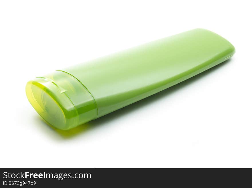 Green plastic cosmetic bottle isolated on white background. Green plastic cosmetic bottle isolated on white background