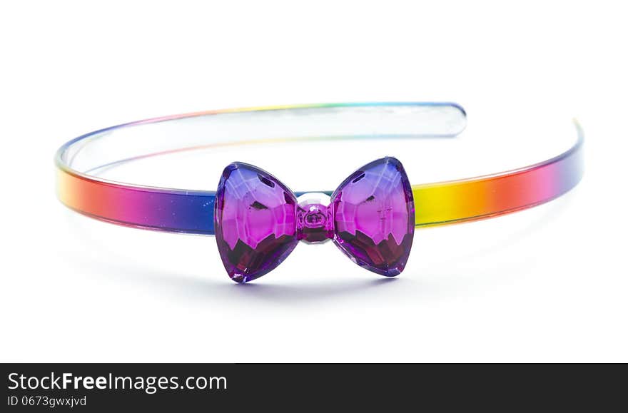 Plastic hairband with bow in rainbow color isolated on white background