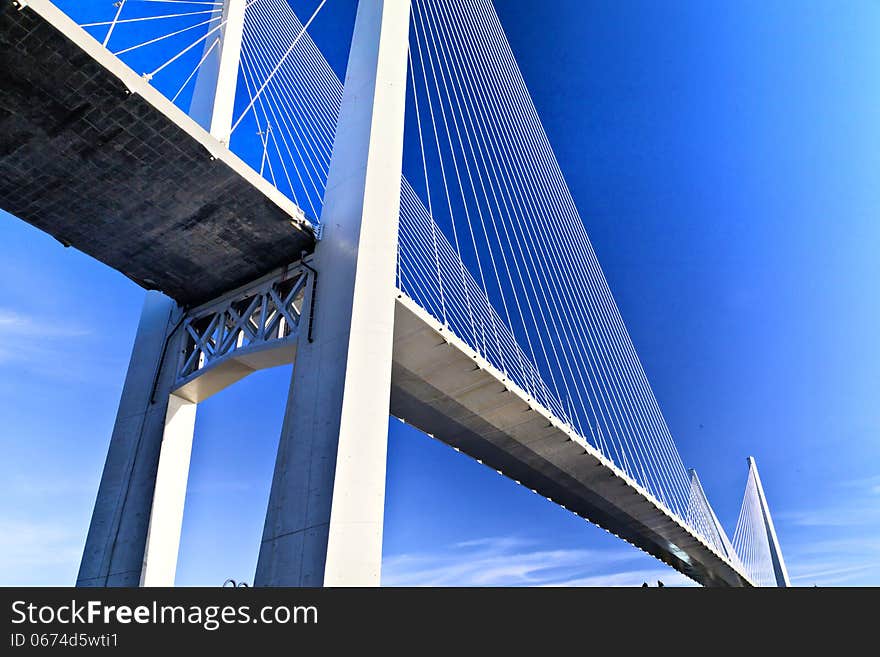 Big suspension bridge over the sea in the middle of the big city