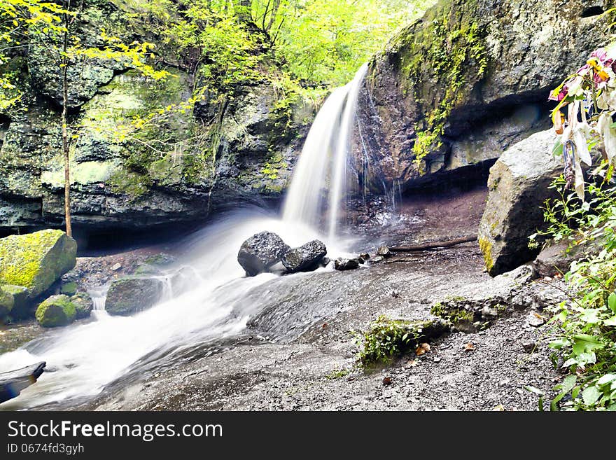 Falls in the dense wood in cloudy day. Falls in the dense wood in cloudy day