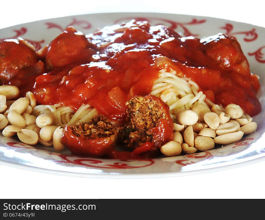 Spaghetti with tomato sauce, meat balls, and peanuts. Spaghetti with tomato sauce, meat balls, and peanuts.