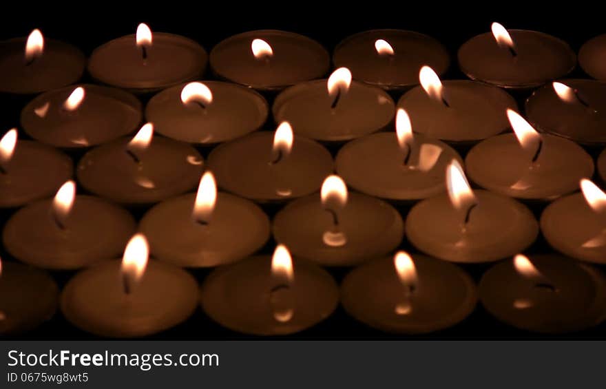 The flame of candles shivers on a wind. The candles blow and becomes darkly, except for one candle. Then and it dies away. The flame of candles shivers on a wind. The candles blow and becomes darkly, except for one candle. Then and it dies away