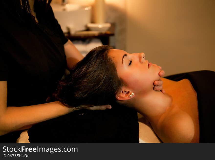 Woman receiving a face massage during spa treatment. Woman receiving a face massage during spa treatment.