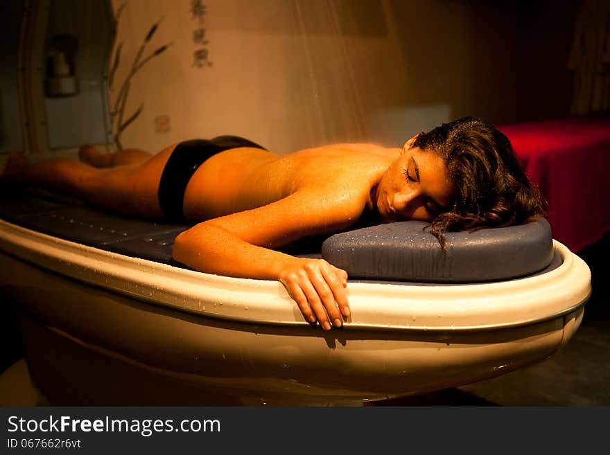 Lying relaxed woman during spa treatment.