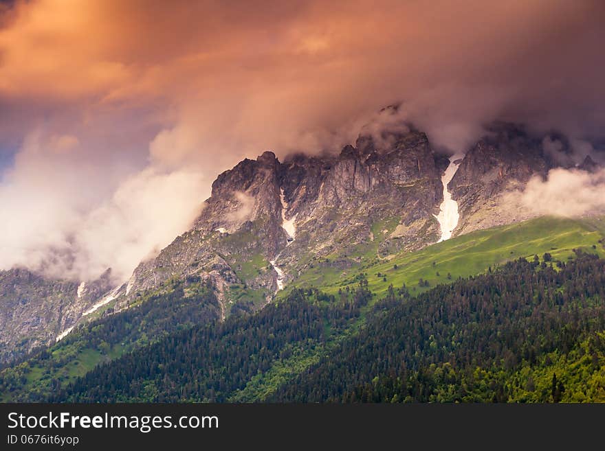 Majestic colorful sunset at the foot of Mt. Ushba. Upper Svaneti, Georgia, Europe. Caucasus mountains. Beauty world.