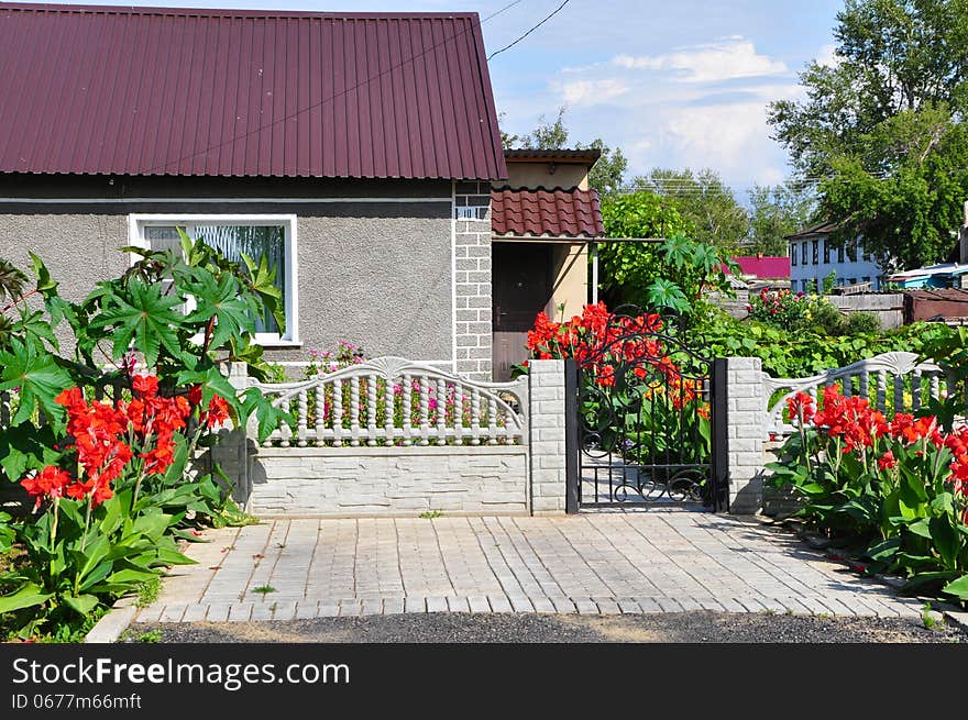 Beautiful home in the summer, decorated with red flowers